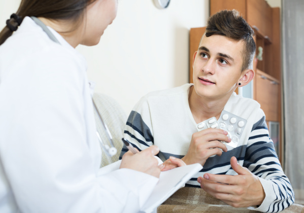Adolescent male with doctor